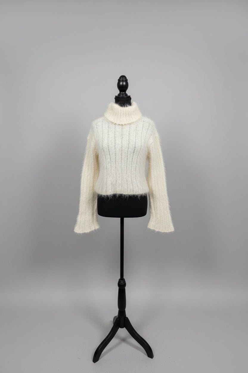 Mannequin wearing a textured sweater in front of a mirror