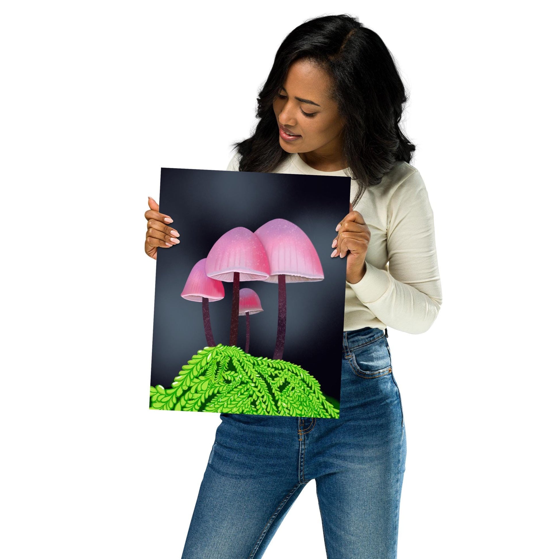 Woman holding a poster with pink mushrooms and green grass design on a white background